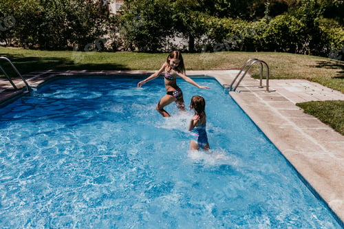 Preview: two beautiful sister kids at the pool playing, running and having fun outdoors. Summertime