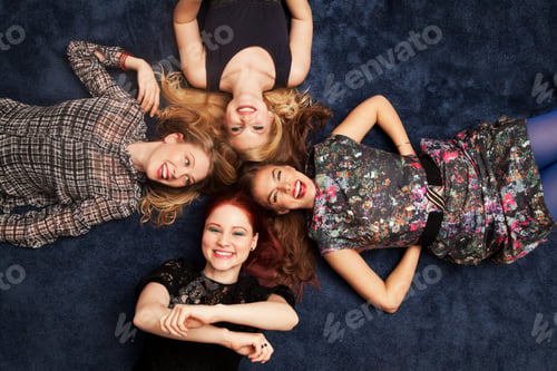 Preview: Group of friends lying on carpeted floor
