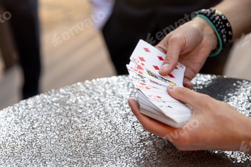 Preview: male hands holding playing card table silver