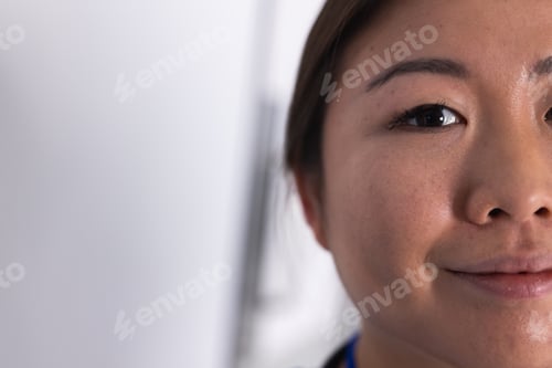 Preview: Half portrait of happy asian female doctor in hospital with copy space