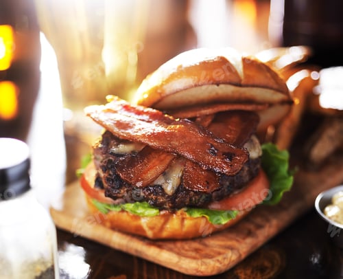 Preview: tasty bacon burger with toasted pretzel bun and beer