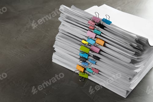 Preview: Stack of documents with binder clips on grey stone table. Space for text