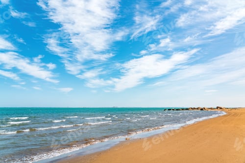 Preview: Empty sandy beach and blue sea with beautiful clouds on blue sky