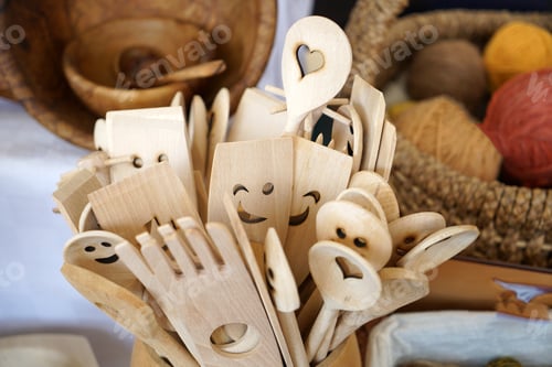 Preview: High angle shot of wooden kitchen utensils in a container with a blurry background