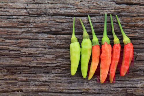 Preview: Hot chili peppers on old wooden