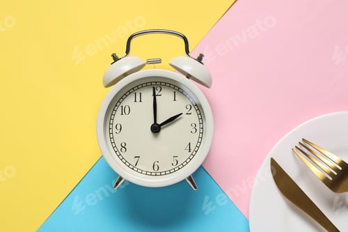 Preview: Time for meal. Alarm clock, plate and cutlery on color background, flat lay
