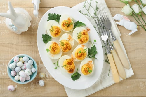Preview: Easter stuffed eggs. Traditional Easter brunch or dinner with stuffed eggs with paprika, carrot cake