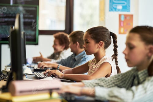 Preview: Group of Diverse Children Using Desktop Computers in Classroom Setting
