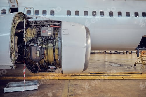 Preview: Airplane engine disassembled open hood in the aviation hangar