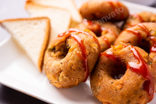 Preview: Instant leftover bread medu vada served with chutney and hot tea, Indian breakfast or snack recipe