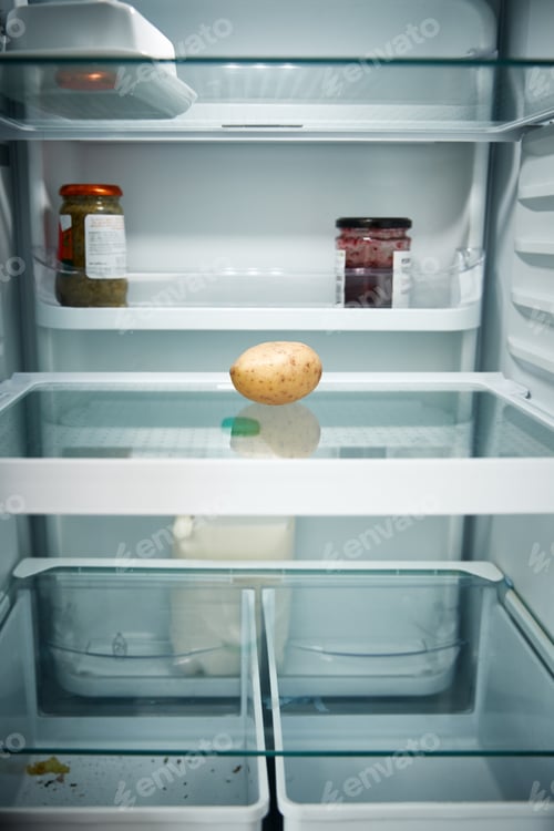 Preview: View Looking Inside Refrigerator Empty Except For Potato On Shelf