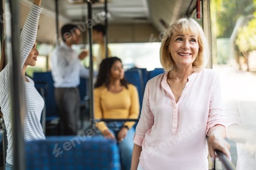 Preview: Beautiful smiling mature woman taking bus, looking out window