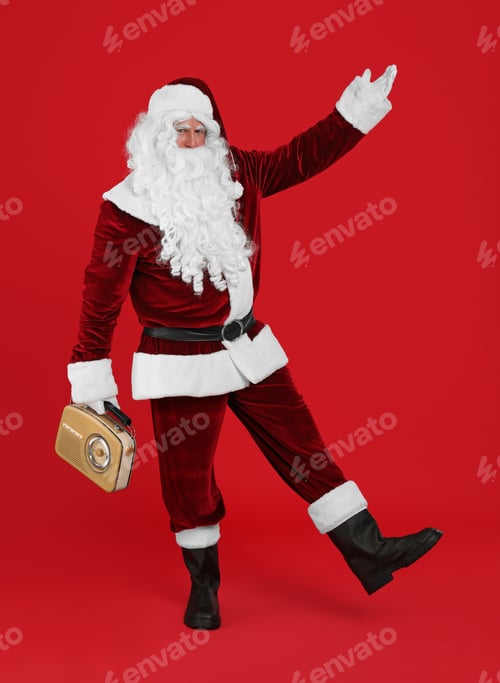 Preview: Santa Claus with vintage radio on red background. Christmas music