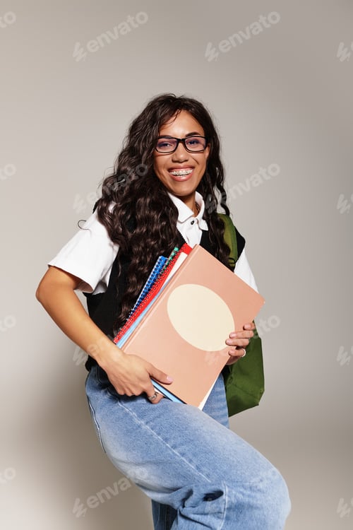 Preview: Confident young student embracing academic life with stylish accessories and a warm smile