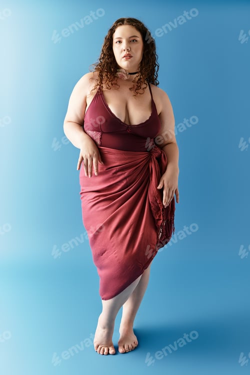 Preview: Elegant young woman exudes confidence in stylish attire against a vibrant blue backdrop