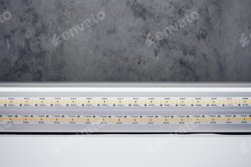 Preview: Strip LED light with aluminum profile on stretch ceiling, close up. Home renovation concept
