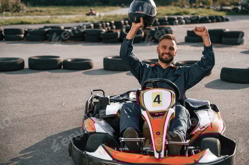Preview: Man Celebrates Go-Kart Race Victory with Helmet