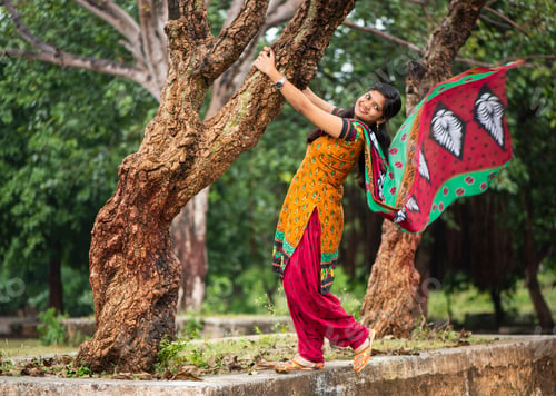 Preview: Young girl near tree trunk and she enjoying fresh air outdoors