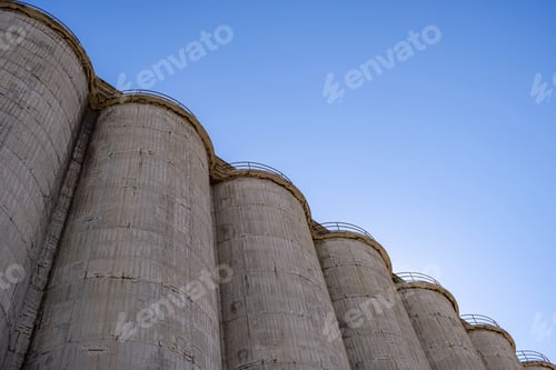Preview: Large concrete industrial silos against blue sky background