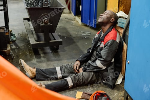 Preview: Resting Worker Sitting in Industrial Workspace