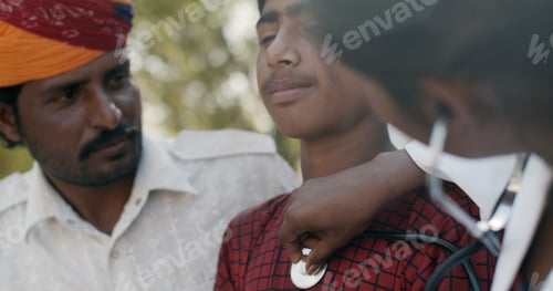 Preview: Young female South Asian doctor doing a checkup on a male child
