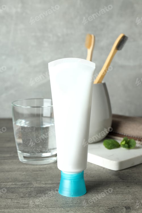 Preview: Concept of tooth care on gray wooden table