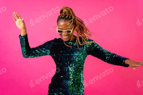 Preview: Black ethnic woman with braids party dancing on pink background, having fun ballerina