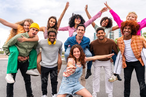 Preview: Happy playful multiethnic group of young friends bonding outdoors