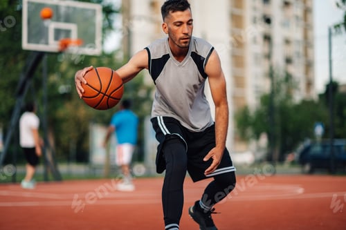Preview: Man dribbling ball on outdoor court