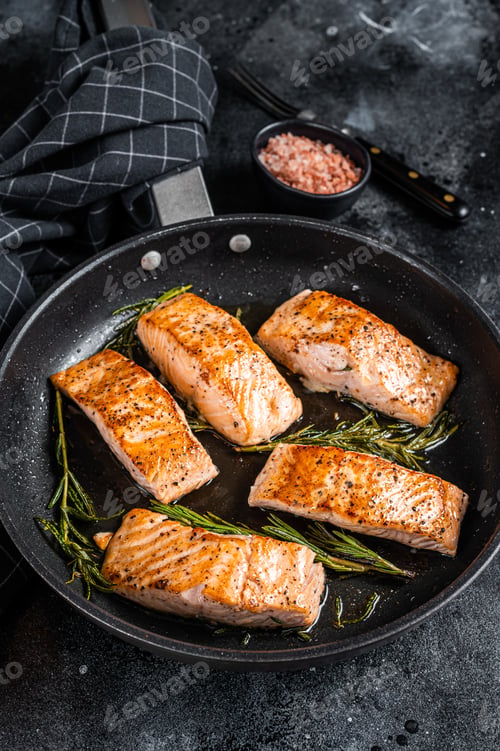 Preview: Grilled Salmon Fillet Steak in a pan. Black background. Top view