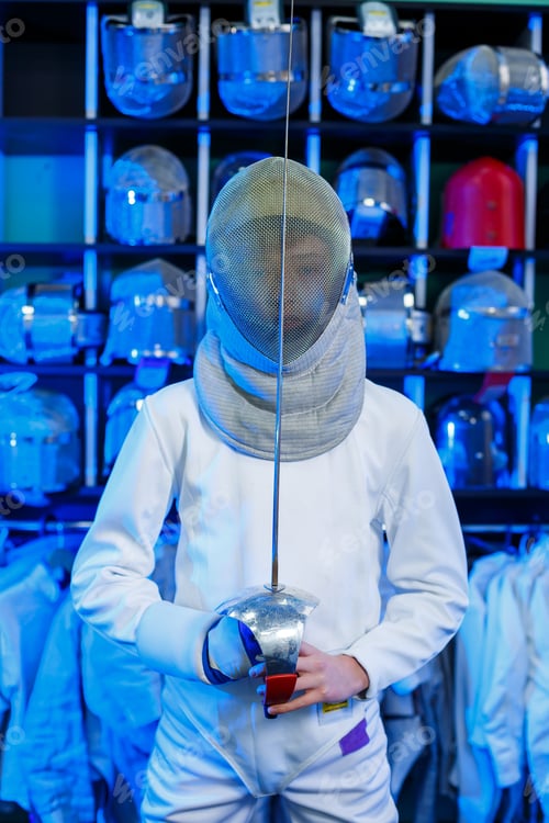 Preview: Young guy in a fencing suit with a sword in his hand, on a blue background, neon light