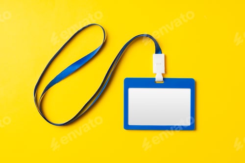 Preview: Blank nametag on a string on yellow background copy space