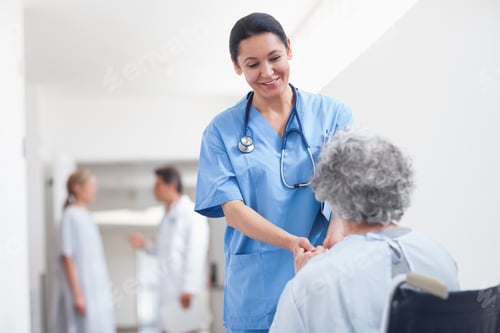 Preview: Nurse Standing Next To A Patient While Holding Her Hands In Hospital Ward