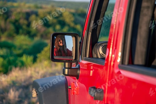 Preview: A young woman driving an SUV in the countryside.