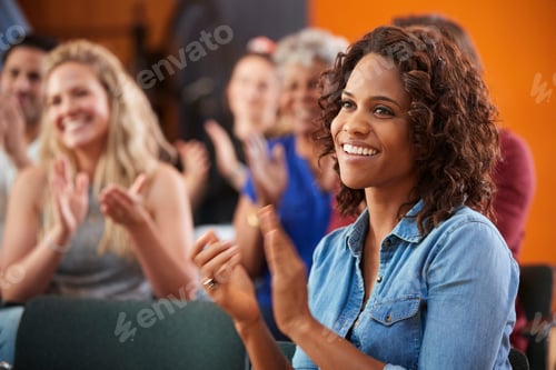 Preview: Group Attending Neighborhood Meeting Applauding Speaker In Community Center