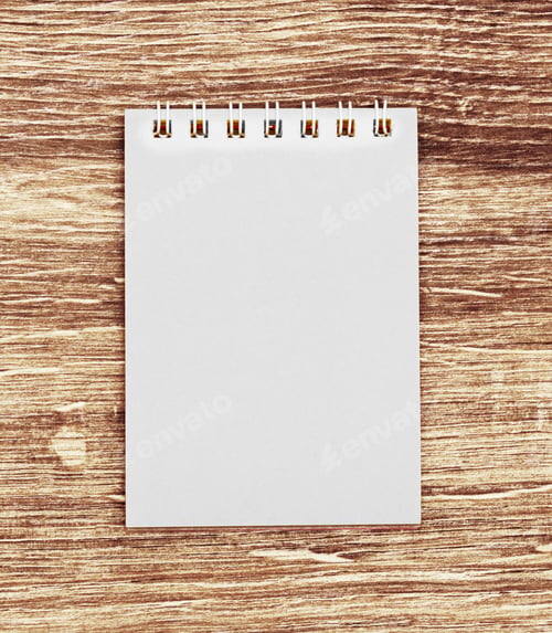 Preview: Notebook on wooden background.