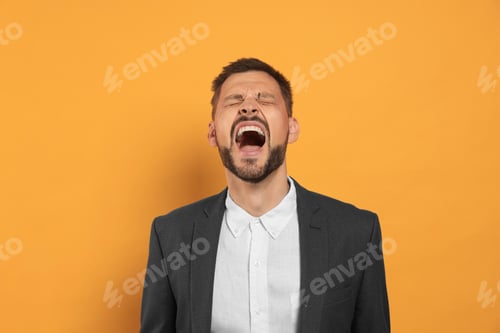 Preview: Aggressive man shouting on orange background. Hate concept