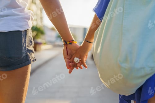 Preview: Couple of unrecognizable women holding hands