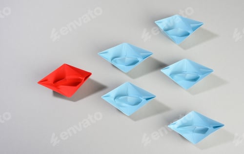 Preview: Group of paper boats on a gray background. concept of a strong leader in a team, manipulation