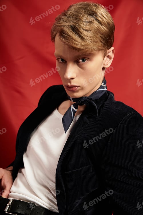 Preview: Modern elegance shines through a young mans confident pose and stylish attire