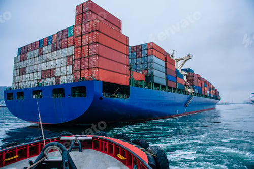 Preview: Tugboat manoeuvring container ship on river, Tacoma, Washington, USA
