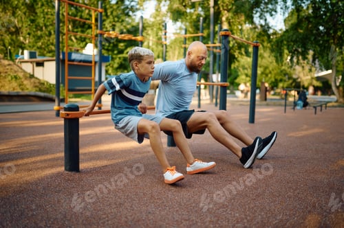 Preview: Father and boy doing exercise, sport training