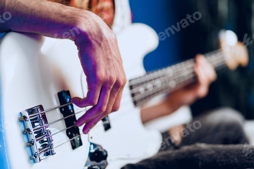 Preview: Close up photo of male hands playing guitar