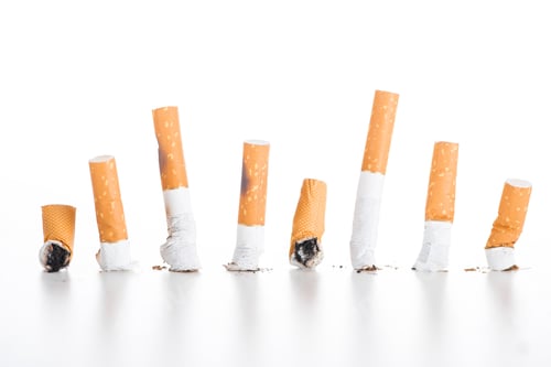 Preview: Studio shot of cigarette butts isolated on white, stop smoking concept