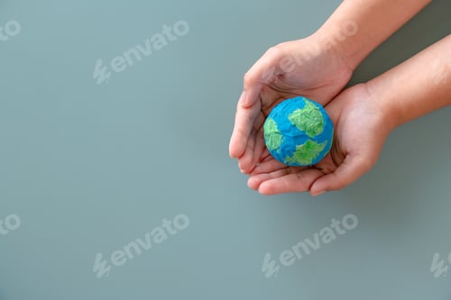 Preview: Hands holding earth paper and water paint. Concept of sustainability environment protection