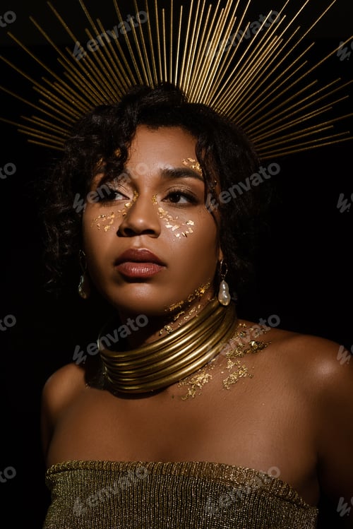 Preview: confident african american woman with golden crown and paint on cheeks looking away isolated