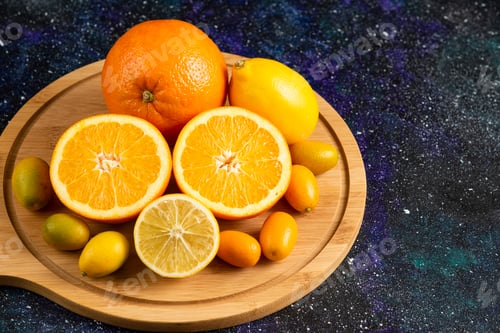 Preview: Fresh citrus fruits on wooden board. Lemon and orange
