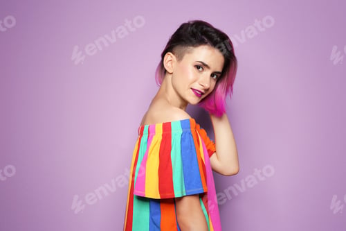 Preview: Young woman with trendy hairstyle against color background