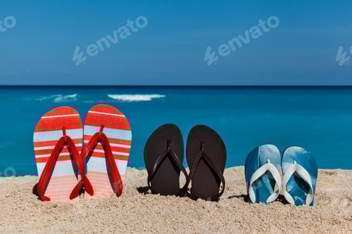 Preview: Summer flip flops on sandy beach