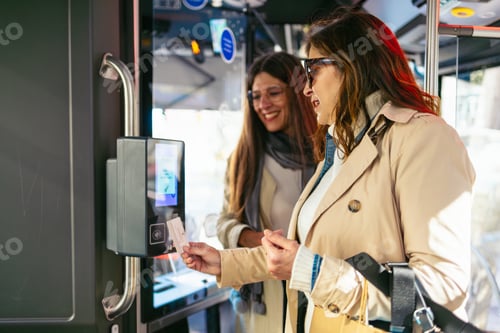 Preview: Women using contactless payment entering bus with shopping bags